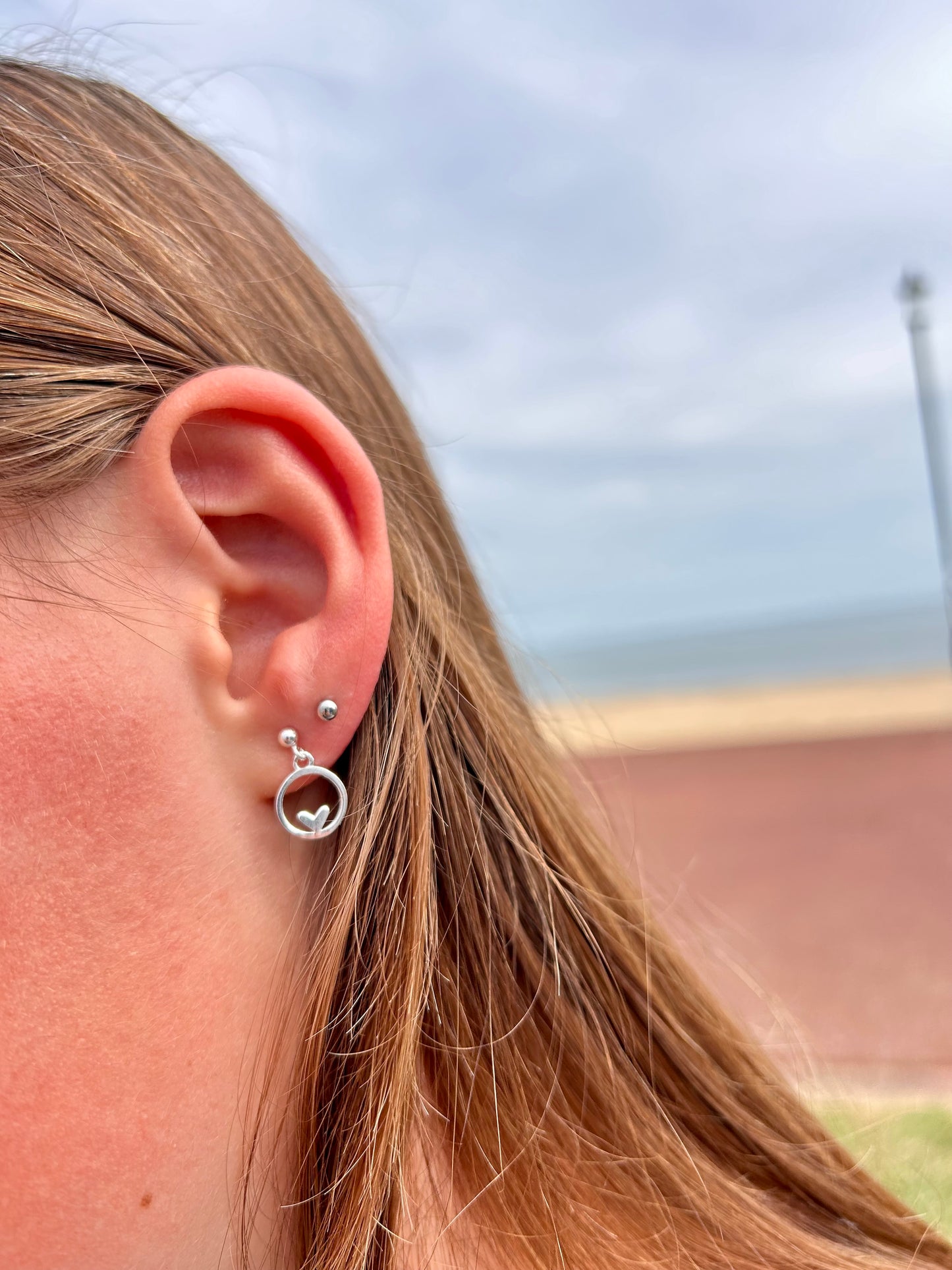 Heart in circle dangly stud earrings